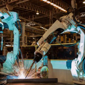 Robotic arms welding in a factory